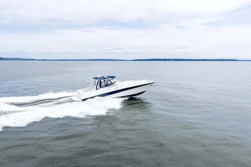  Yacht Photos Pics 2008 Fountain 38 Sportfish Cruiser speeding on open water under a cloudy sky.