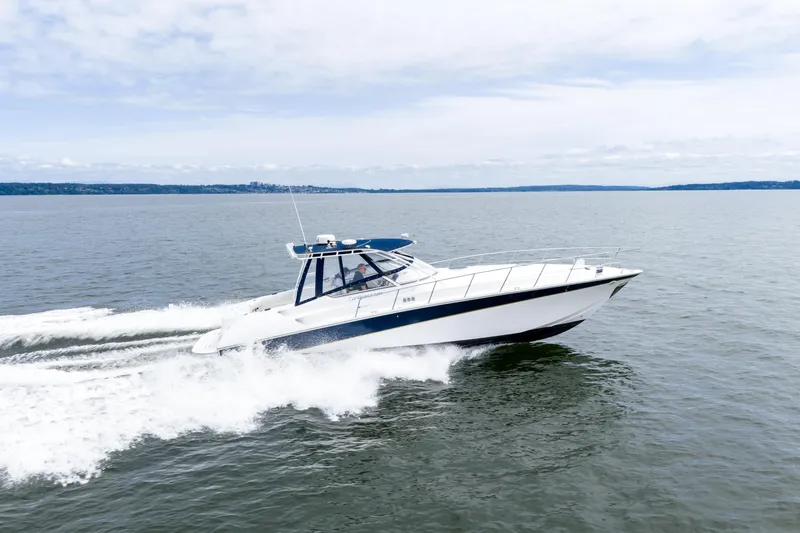  Yacht Photos Pics 2008 Fountain 38 Sportfish Cruiser speeding on open water under a clear sky.