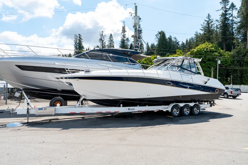  Yacht Photos Pics 2008 Fountain 38 Sportfish Cruiser on trailer, parked outdoors under a blue sky.