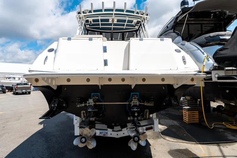  Yacht Photos Pics 2008 Fountain 38 Sportfish Cruiser, rear view, docked with visible propellers and blue sky background.