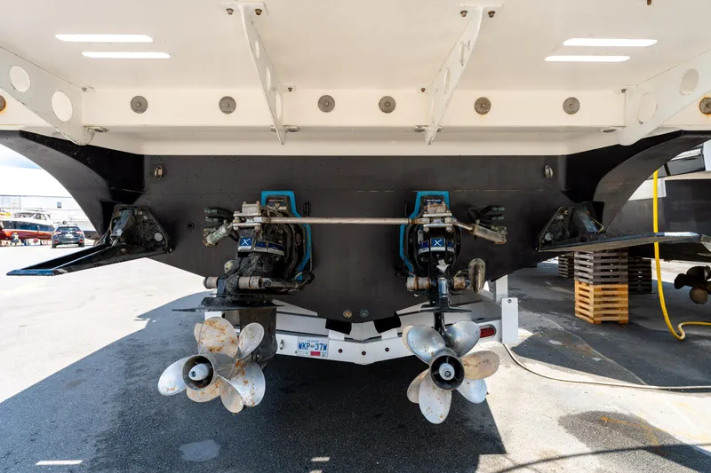  Yacht Photos Pics 2008 Fountain 38 Sportfish Cruiser's dual propellers and stern view in a marina setting.