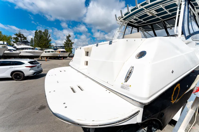  Yacht Photos Pics 2008 Fountain 38 Sportfish Cruiser docked, with a white SUV nearby under a blue sky.