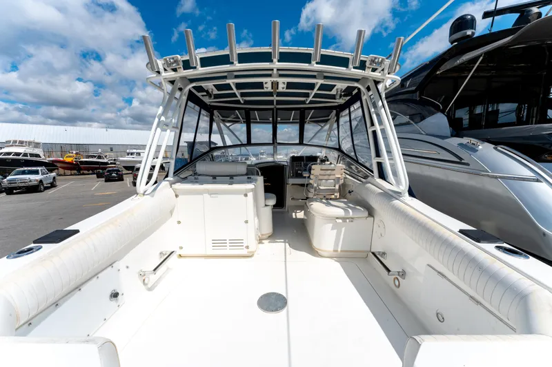  Yacht Photos Pics 2008 Fountain 38 Sportfish Cruiser boat with spacious deck and seating, docked under blue sky.