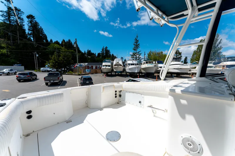  Yacht Photos Pics 2008 Fountain 38 Sportfish Cruiser docked, surrounded by parked cars and trees under a blue sky.