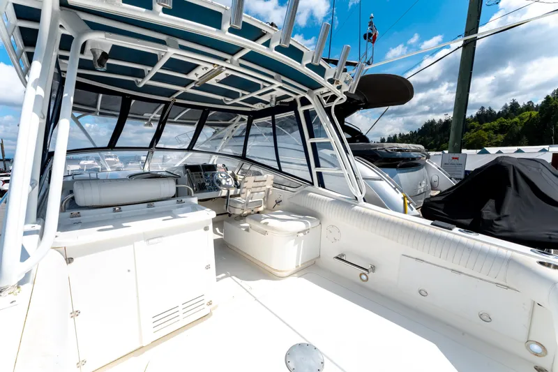  Yacht Photos Pics 2008 Fountain 38 Sportfish Cruiser interior with helm, seating, and open deck under blue sky.