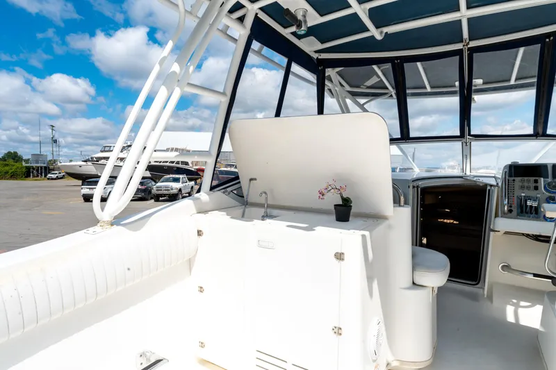  Yacht Photos Pics 2008 Fountain 38 Sportfish Cruiser interior with seating, helm, and small potted plant.