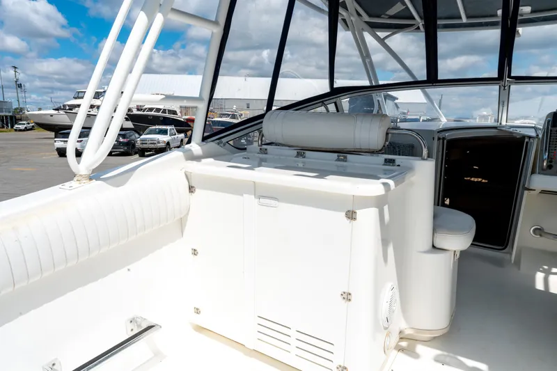  Yacht Photos Pics 2008 Fountain 38 Sportfish Cruiser interior with seating and storage, docked under a blue sky.