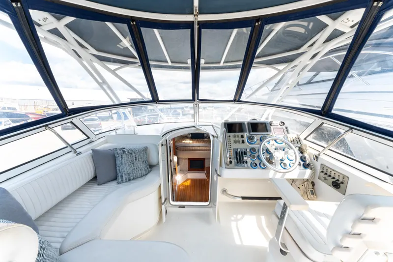  Yacht Photos Pics 2008 Fountain 38 Sportfish Cruiser cockpit with helm, seating, and navigation controls.