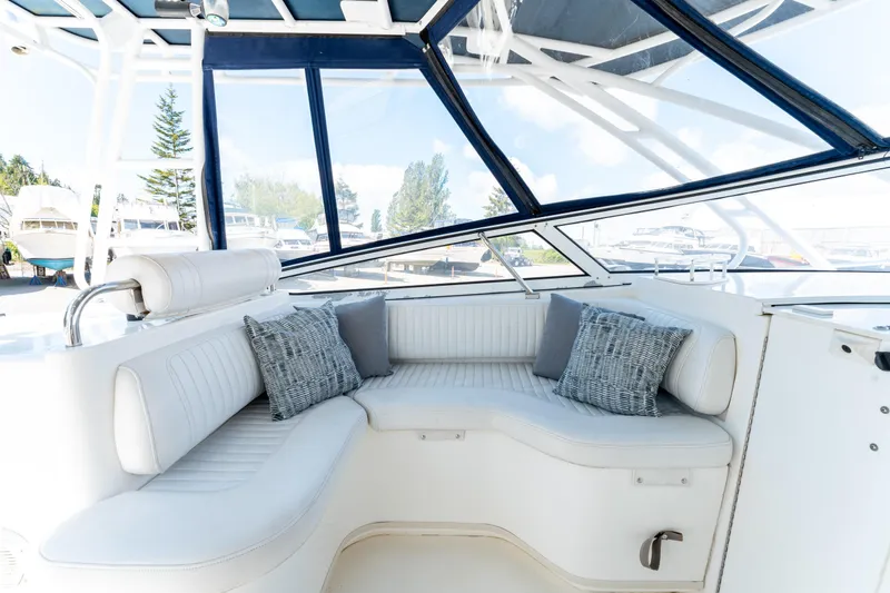  Yacht Photos Pics 2008 Fountain 38 Sportfish Cruiser interior with white seating and decorative cushions.