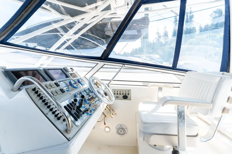  Yacht Photos Pics Helm of 2008 Fountain 38 Sportfish Cruiser with modern controls and white captain's chair.
