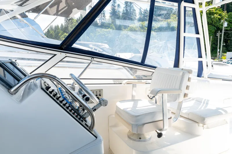  Yacht Photos Pics 2008 Fountain 38 Sportfish Cruiser helm with white seating and control panel.