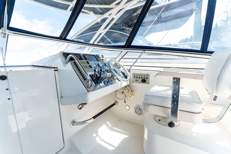  Yacht Photos Pics 2008 Fountain 38 Sportfish Cruiser helm with steering wheel and control panel.