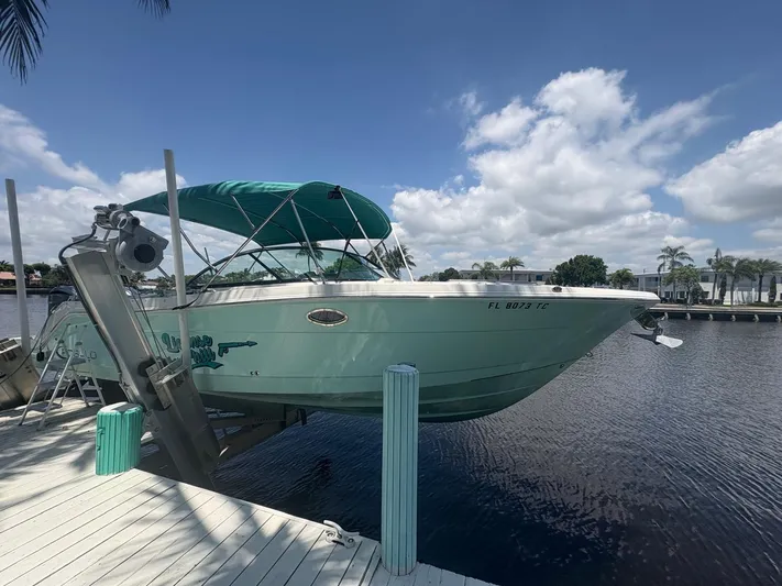  Yacht Photos Pics 2022 Robalo R317 Dual Console boat docked by a sunny waterfront.