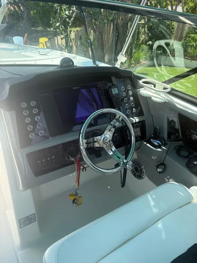  Yacht Photos Pics 2022 Robalo R317 Dual Console boat cockpit with modern steering and control panel.