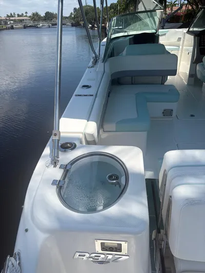  Yacht Photos Pics 2022 Robalo R317 Dual Console boat interior with seating and water view.