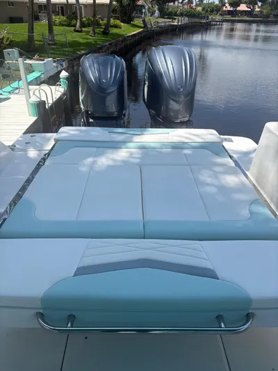  Yacht Photos Pics 2022 Robalo R317 Dual Console boat with twin engines docked by a serene waterfront.