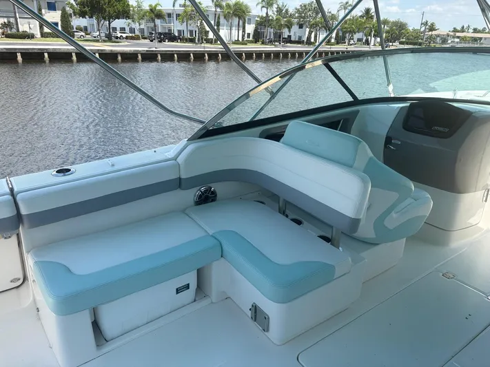  Yacht Photos Pics 2022 Robalo R317 Dual Console boat interior with seating, near waterfront.