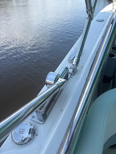  Yacht Photos Pics 2022 Robalo R317 Dual Console boat railing and deck detail by the water.