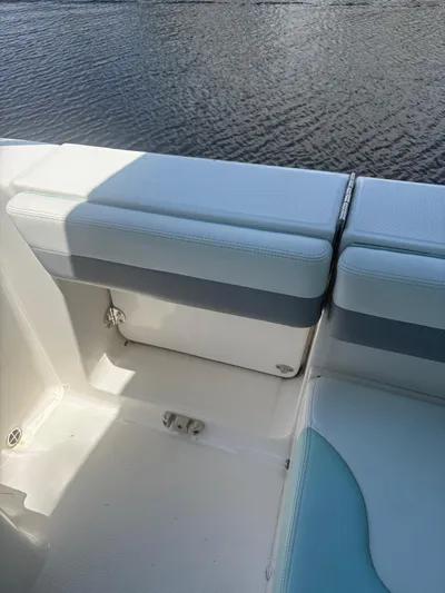  Yacht Photos Pics 2022 Robalo R317 Dual Console boat interior with cushioned seating by the water.
