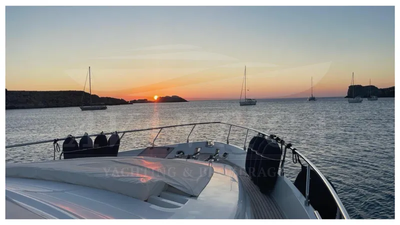  Yacht Photos Pics Ferretti Yachts 680, 2003 model, cruising at sunset with sailboats in the background.