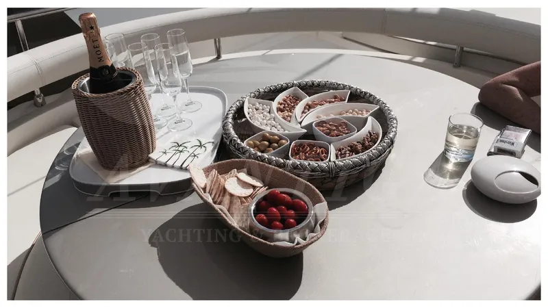  Yacht Photos Pics Luxurious yacht dining setup with snacks and champagne on a Ferretti Yachts 680, 2003 model.