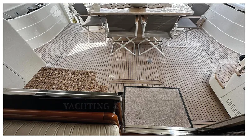 Yacht Photos Pics Outdoor seating area on 2003 Ferretti Yachts 680 with teak flooring and dining setup.