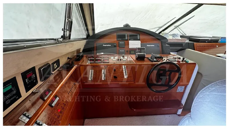  Yacht Photos Pics Helm of 2003 Ferretti Yachts 680 with navigation controls and steering wheel.