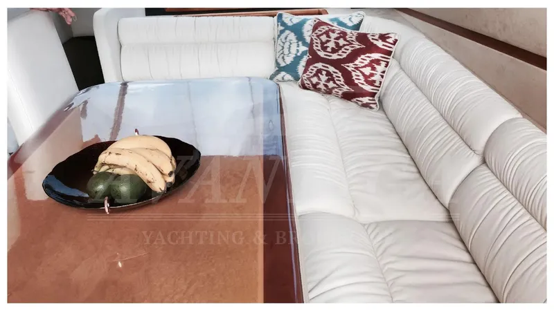  Yacht Photos Pics Luxurious interior of 2003 Ferretti Yachts 680 with white seating and decorative pillows.