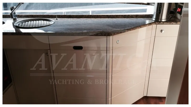  Yacht Photos Pics Interior view of 2003 Ferretti Yachts 680 kitchen area with sleek cabinetry and countertop.