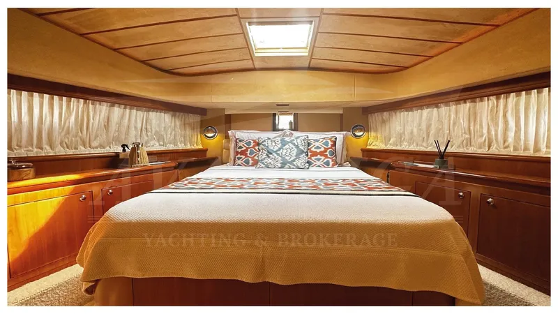 Yacht Photos Pics Luxurious bedroom interior of 2003 Ferretti Yachts 680 with elegant wood finish.