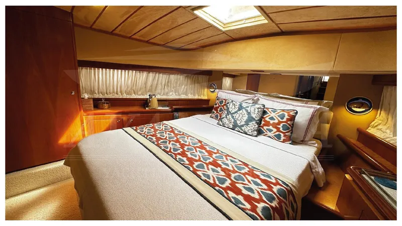  Yacht Photos Pics Luxurious bedroom interior of 2003 Ferretti Yachts 680 with elegant bedding and wood accents.