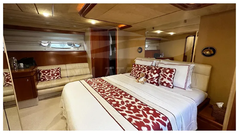  Yacht Photos Pics Luxurious bedroom interior of 2003 Ferretti Yachts 680 with elegant bedding and seating area.
