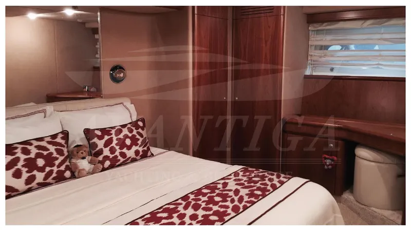  Yacht Photos Pics Luxurious bedroom interior of 2003 Ferretti Yachts 680 with elegant decor and wood finishes.