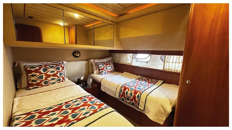  Yacht Photos Pics Luxurious twin cabin interior of 2003 Ferretti Yachts 680 with patterned bedding.