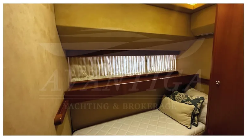  Yacht Photos Pics Cozy cabin interior of 2003 Ferretti Yachts 680 with bed and window.