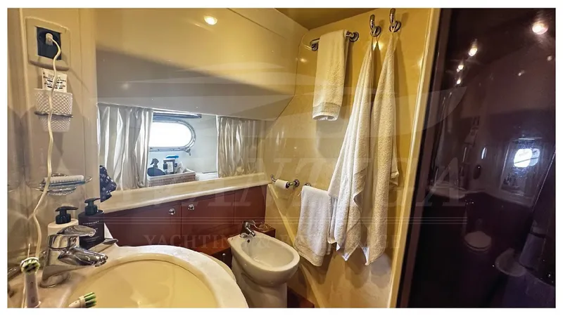  Yacht Photos Pics Luxurious bathroom in 2003 Ferretti Yachts 680, featuring elegant fixtures and ample natural light.
