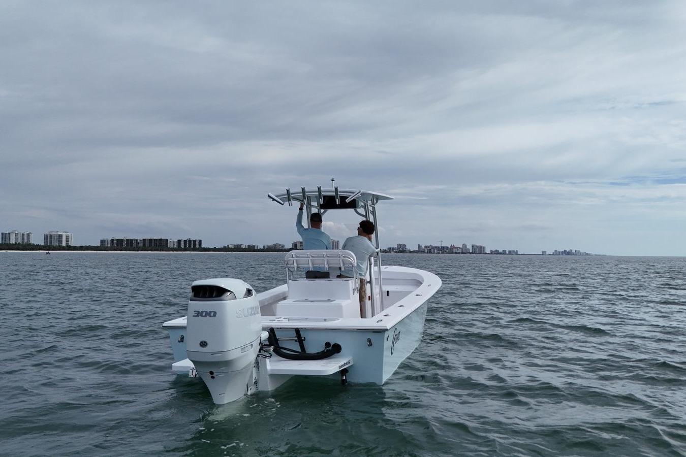 2026 C-Hawk 25 Center Console boat cruising on open water near city skyline.