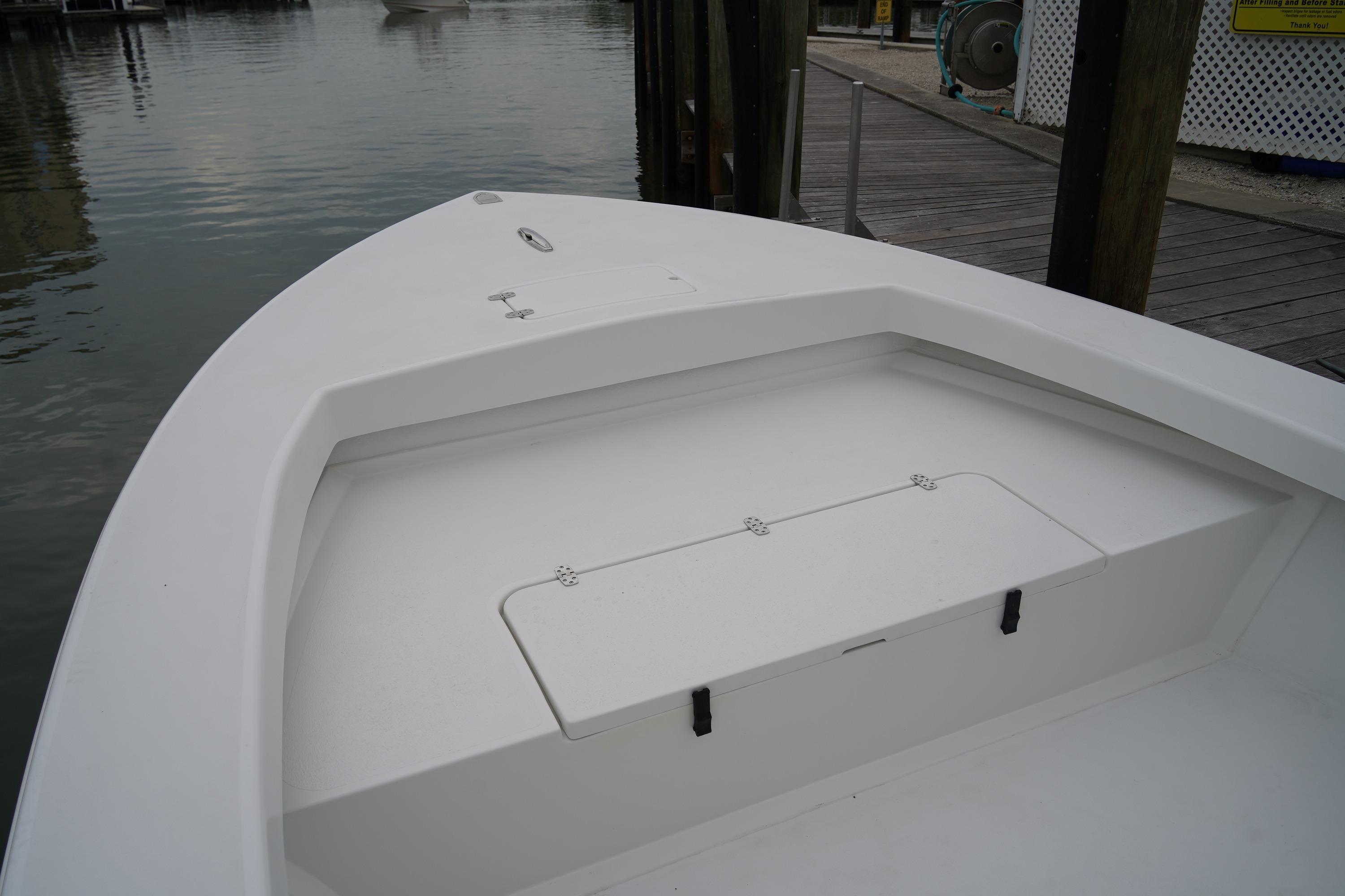 2026 C-Hawk 25 Center Console boat docked at marina, showcasing bow storage area.