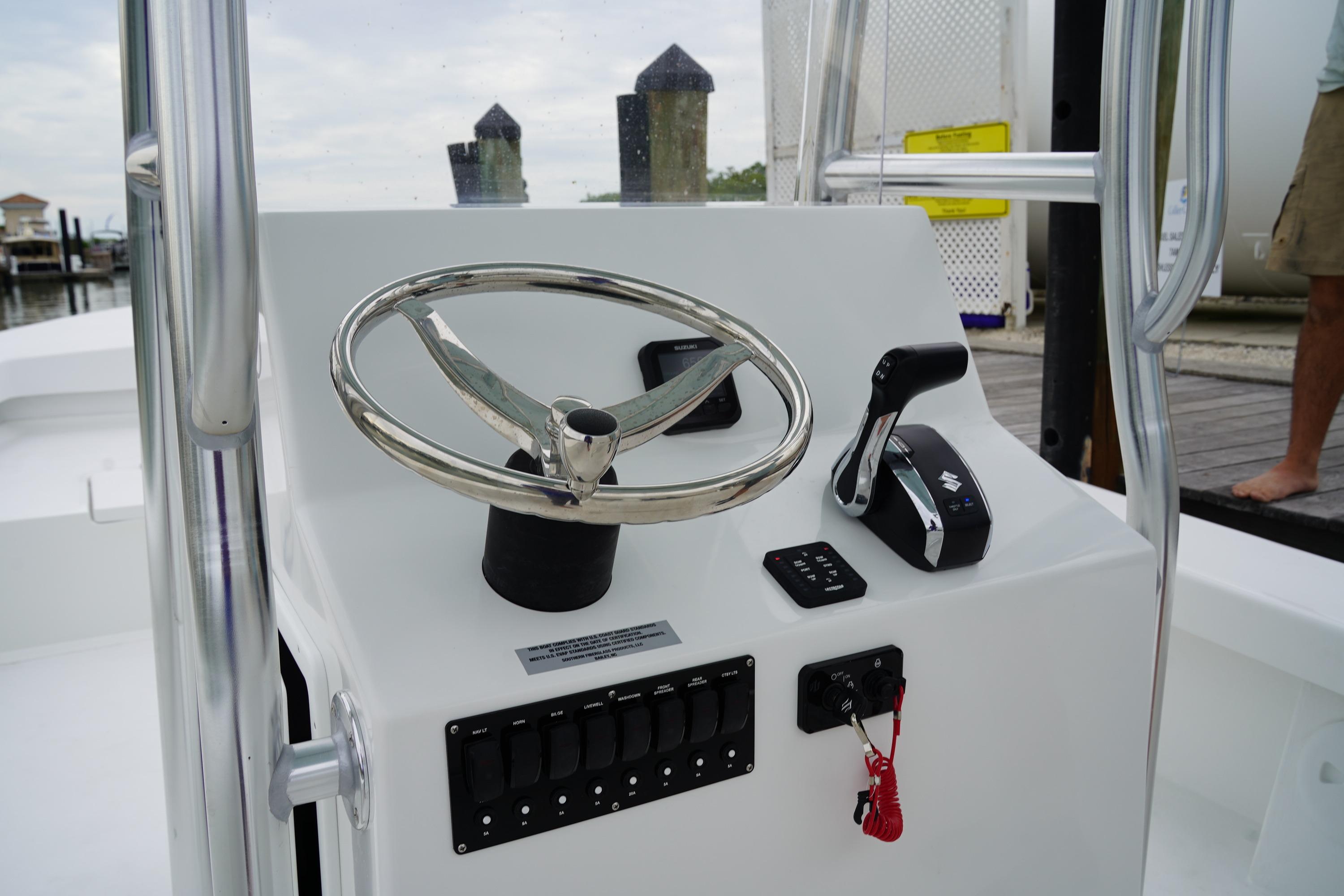 2026 C-Hawk 25 Center Console boat steering console with controls and switches.