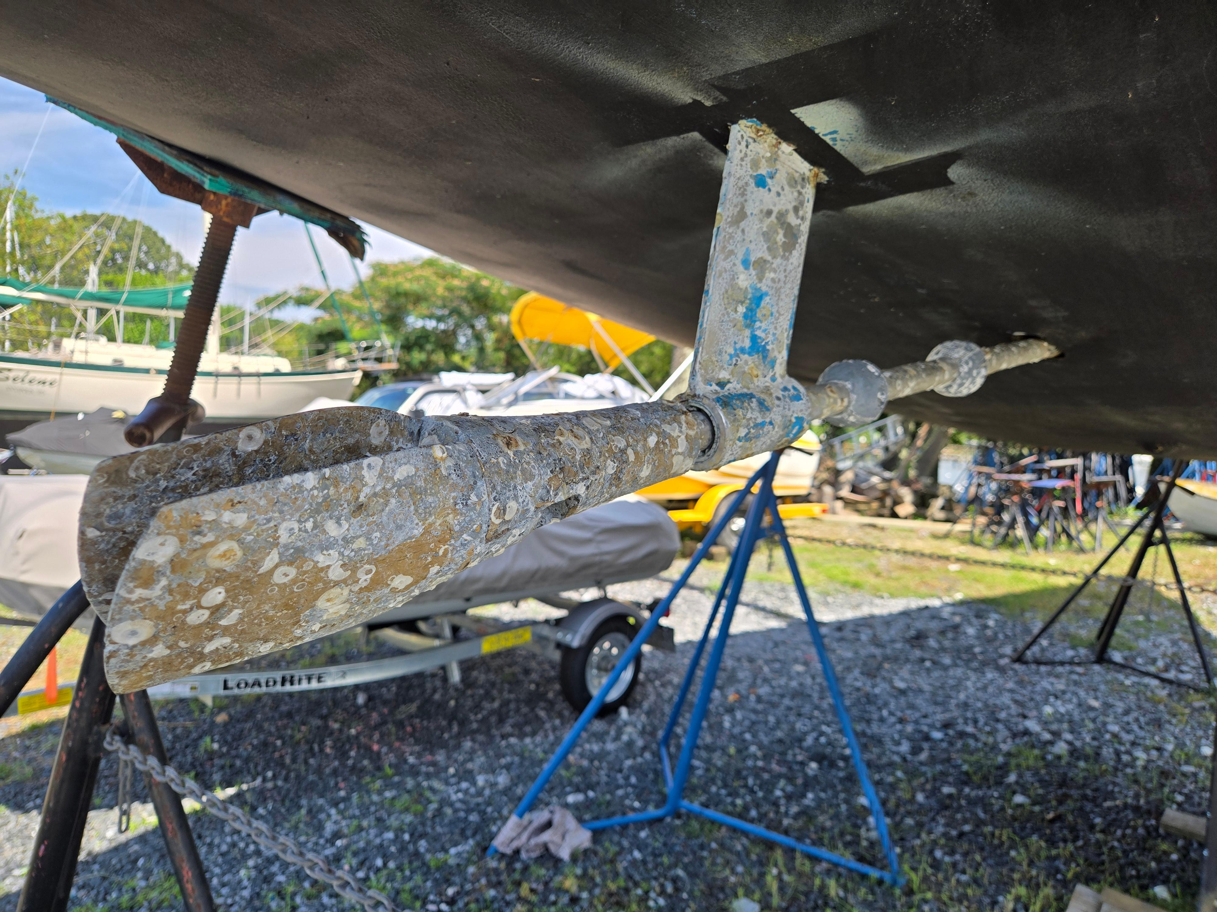 Dehler Optima 34 (1987) sailboat propeller and rudder detail in a boatyard.