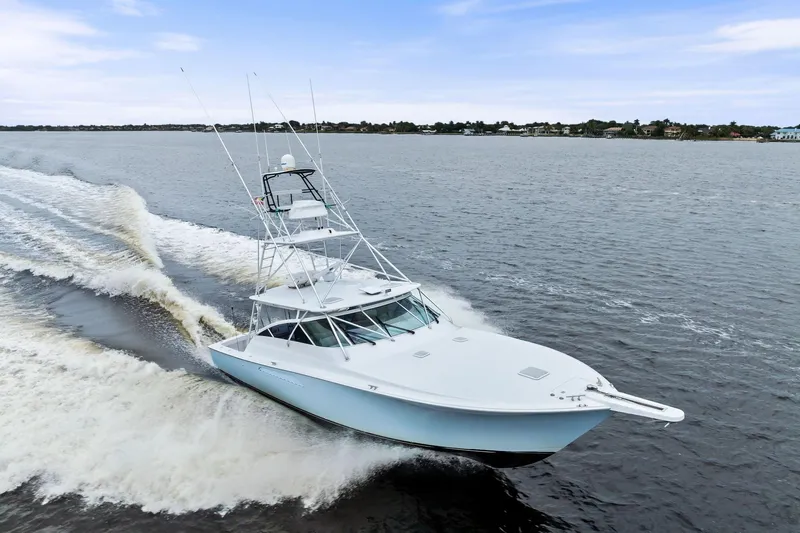 Urgent Sea Yacht Photos Pics 2003 Viking 45 Open yacht cruising on open water, creating a dynamic wake.