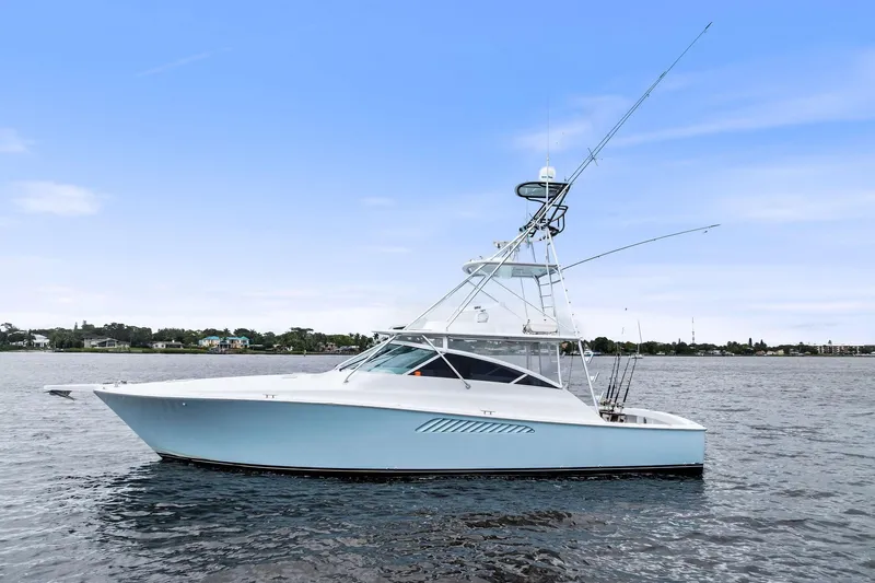 Urgent Sea Yacht Photos Pics 2003 Viking 45 Open yacht on calm water under clear blue sky.