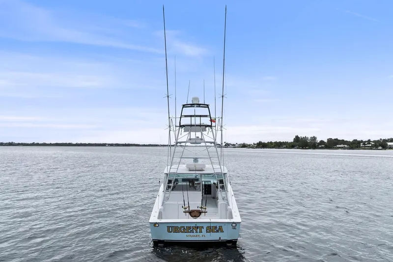 Urgent Sea Yacht Photos Pics 2003 Viking 45 Open boat on calm water, rear view with clear sky.