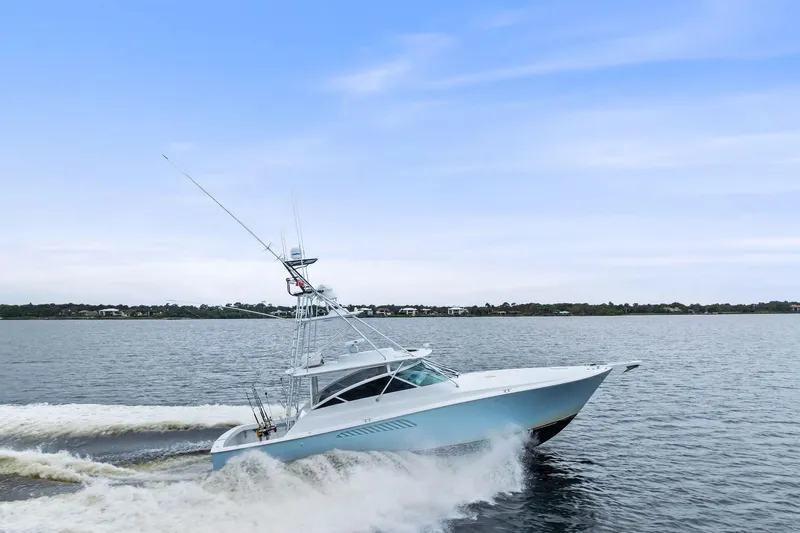 Urgent Sea Yacht Photos Pics 2003 Viking 45 Open yacht cruising on a calm sea under a clear sky.