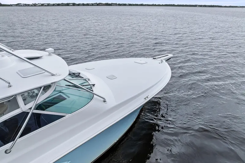 Urgent Sea Yacht Photos Pics 2003 Viking 45 Open yacht on calm waters, showcasing sleek design and craftsmanship.