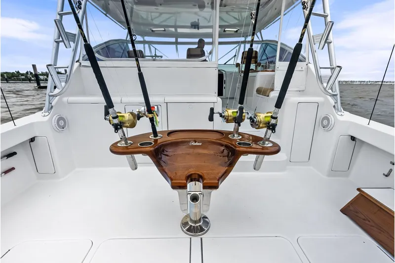 Urgent Sea Yacht Photos Pics 2003 Viking 45 Open fishing boat cockpit with rods and wooden fighting chair.