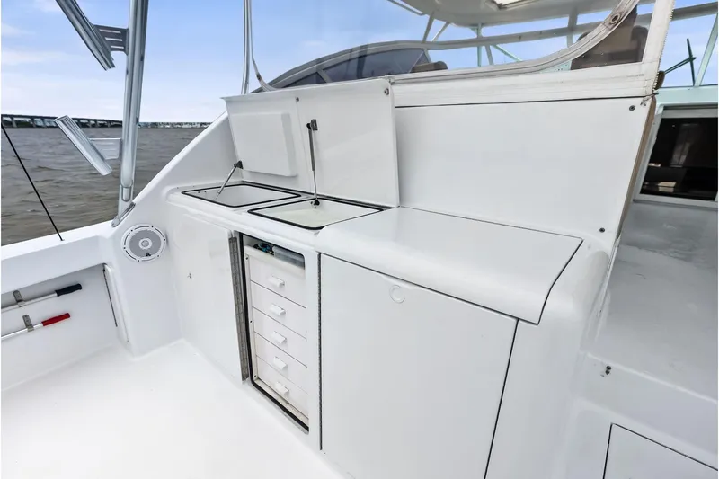 Urgent Sea Yacht Photos Pics 2003 Viking 45 Open yacht interior with storage and sink, featuring sleek white design.