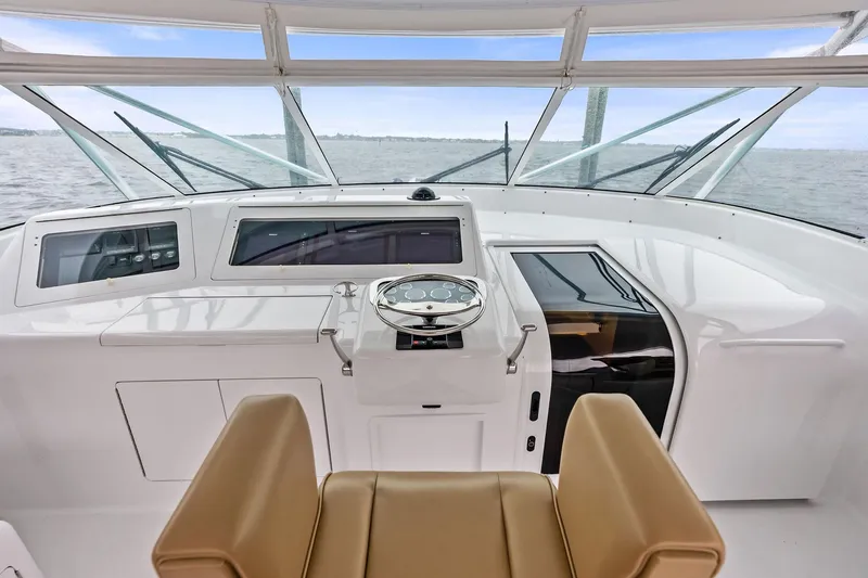 Urgent Sea Yacht Photos Pics 2003 Viking 45 Open yacht helm with tan seating and ocean view.