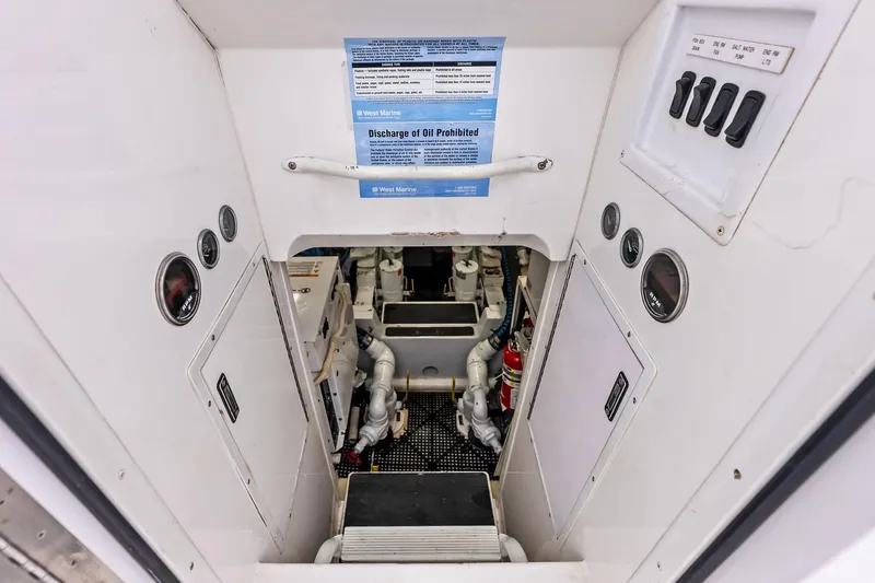 Urgent Sea Yacht Photos Pics Engine room of 2003 Viking 45 Open boat, featuring gauges and control panel.