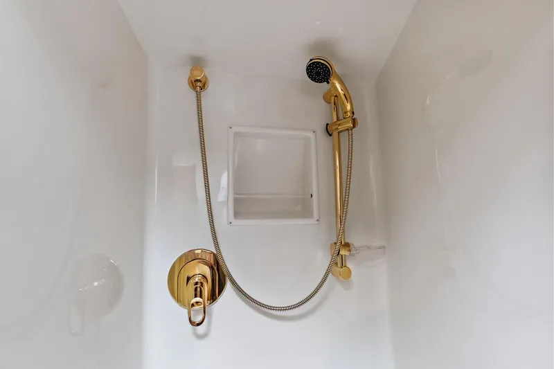 Urgent Sea Yacht Photos Pics Luxurious gold shower fixtures in 2003 Viking 45 Open yacht bathroom.